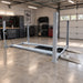 Angled side view of Triumph NSS-11 Four-Post Lift installed in a workshop