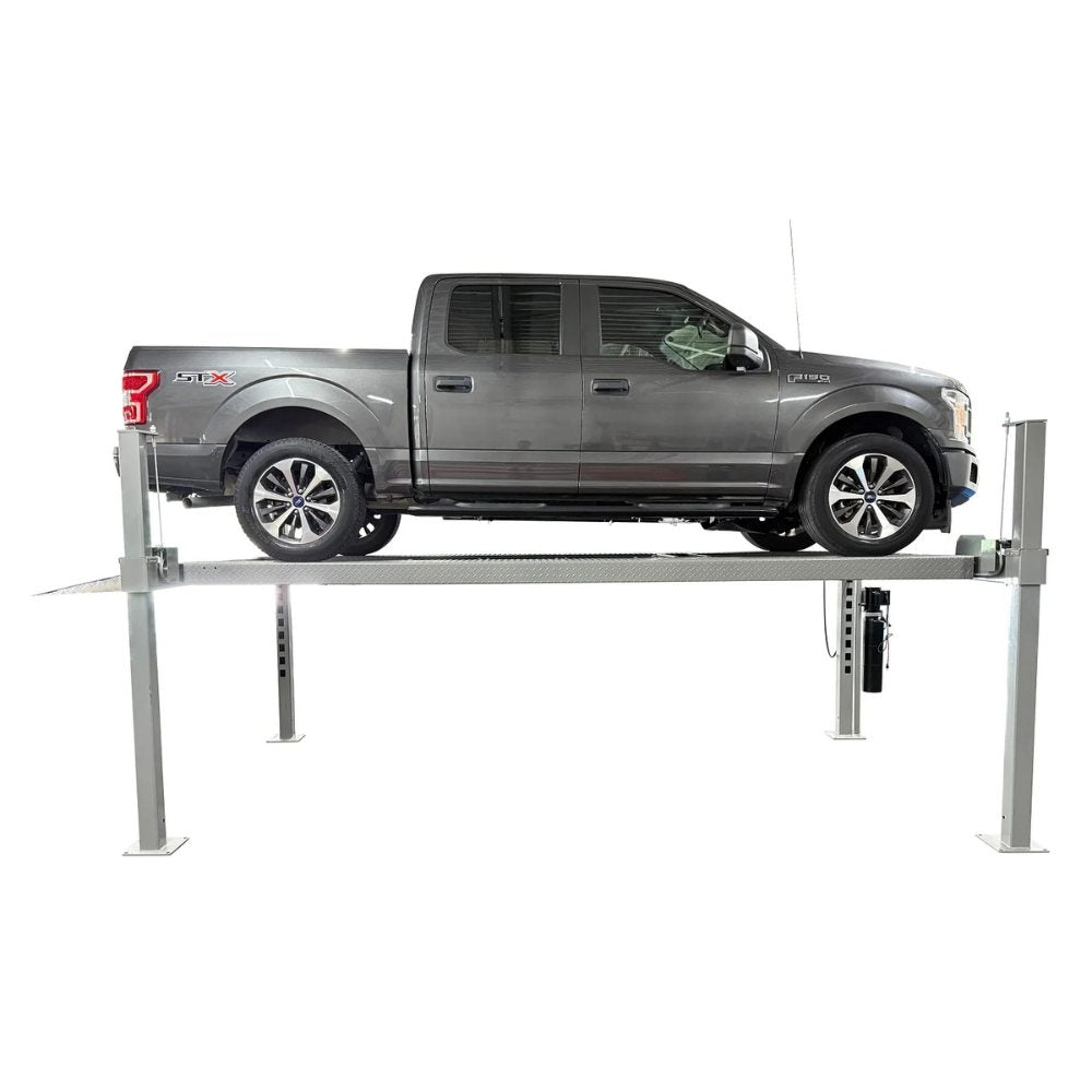 Triumph NOS10000 Four-Post Lift side view with a pickup truck raised on the lift