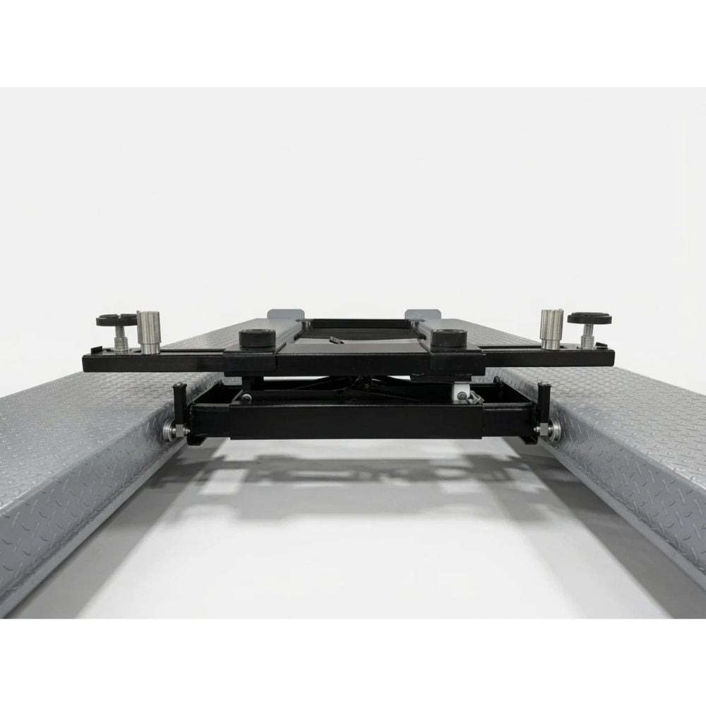Triumph RJ-5000 5,000 lb Rolling Bridge Jack lowered between four-post lift runways
